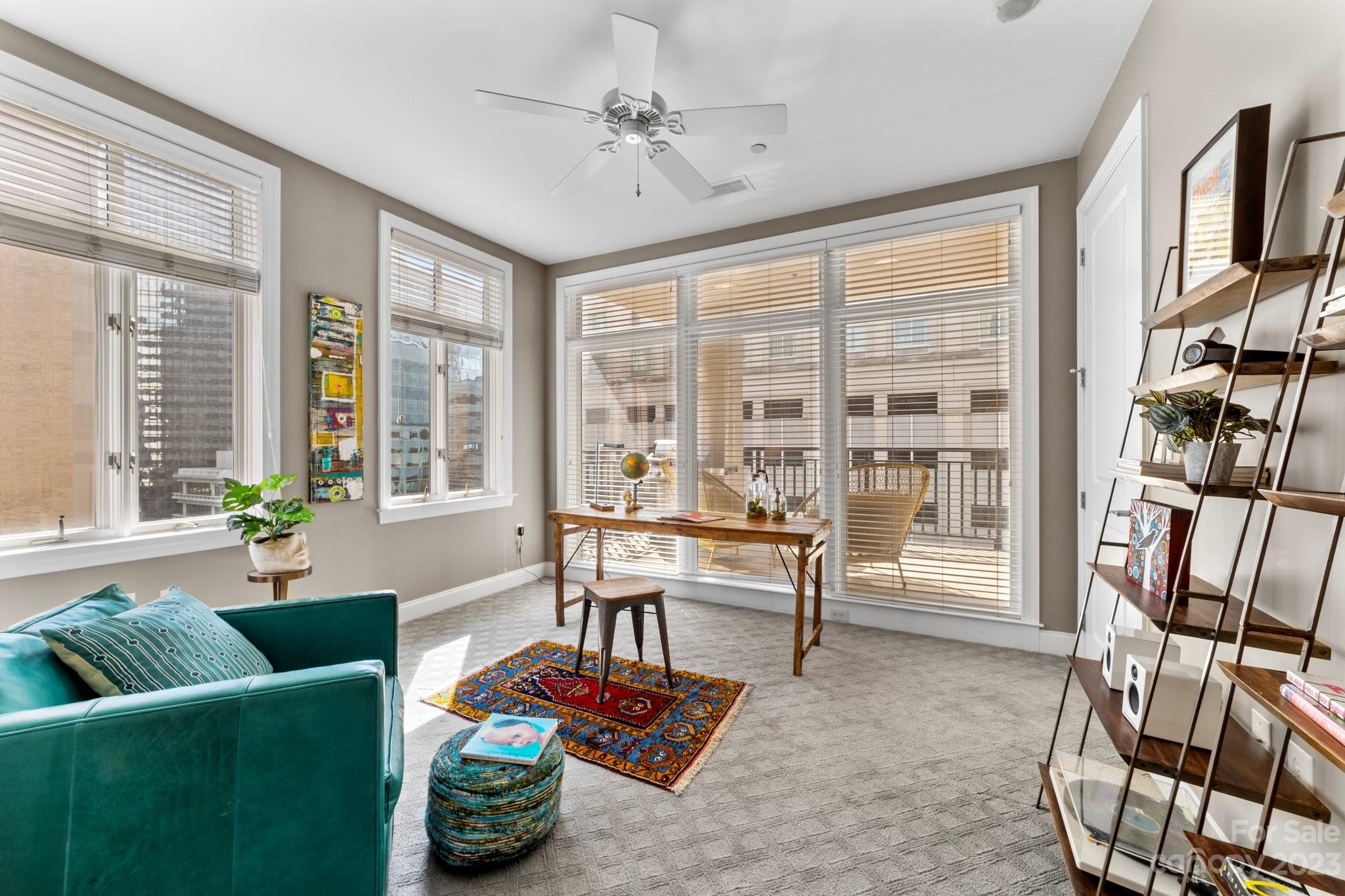 230 South Tryon Street, Unit 906 Charlotte, NC 28202 - Photo 20 of 27 a living room with furniture and a floor to ceiling window