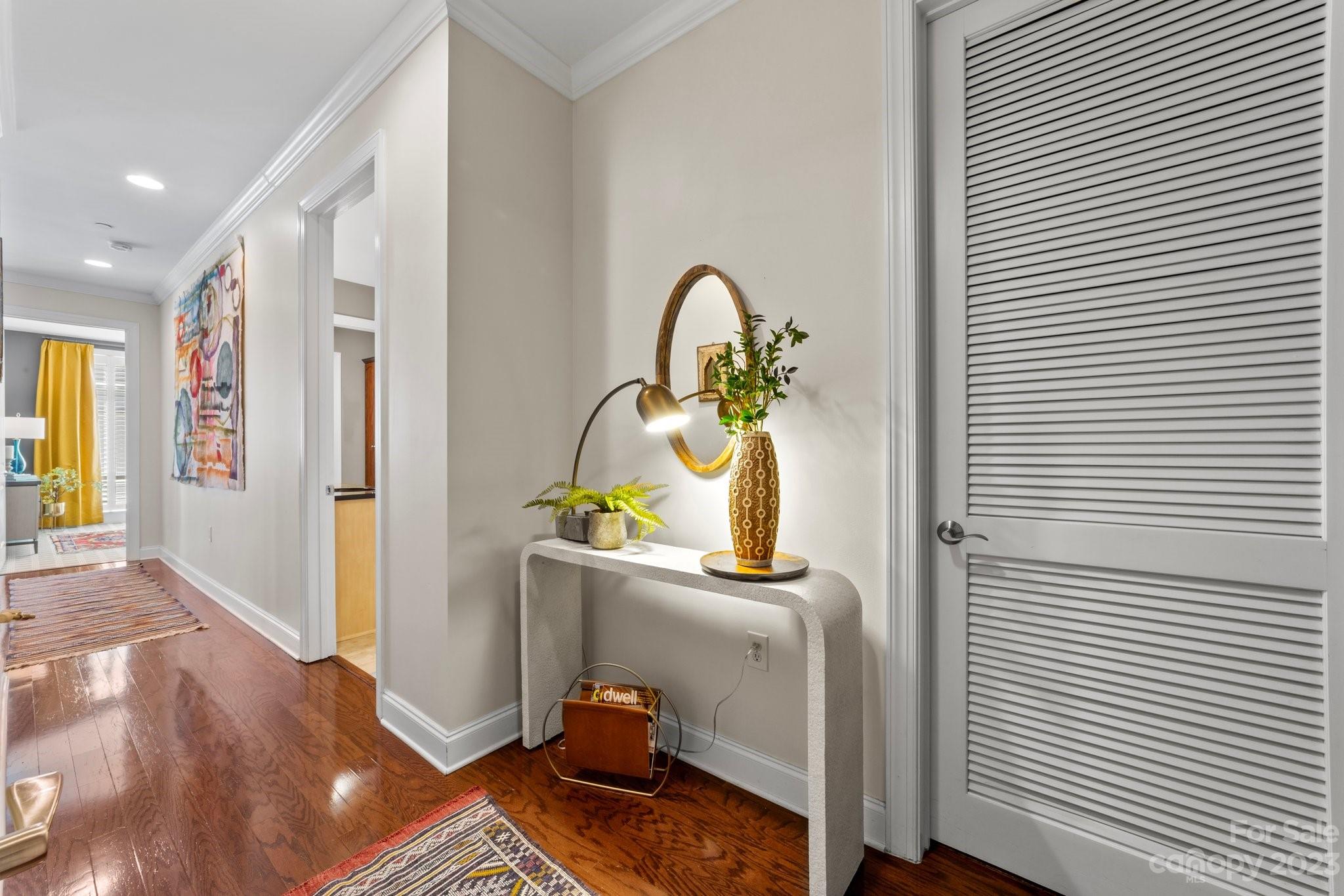 230 South Tryon Street, Unit 906 Charlotte, NC 28202 - Photo 2 of 27 a bedroom with a bed and wooden floor