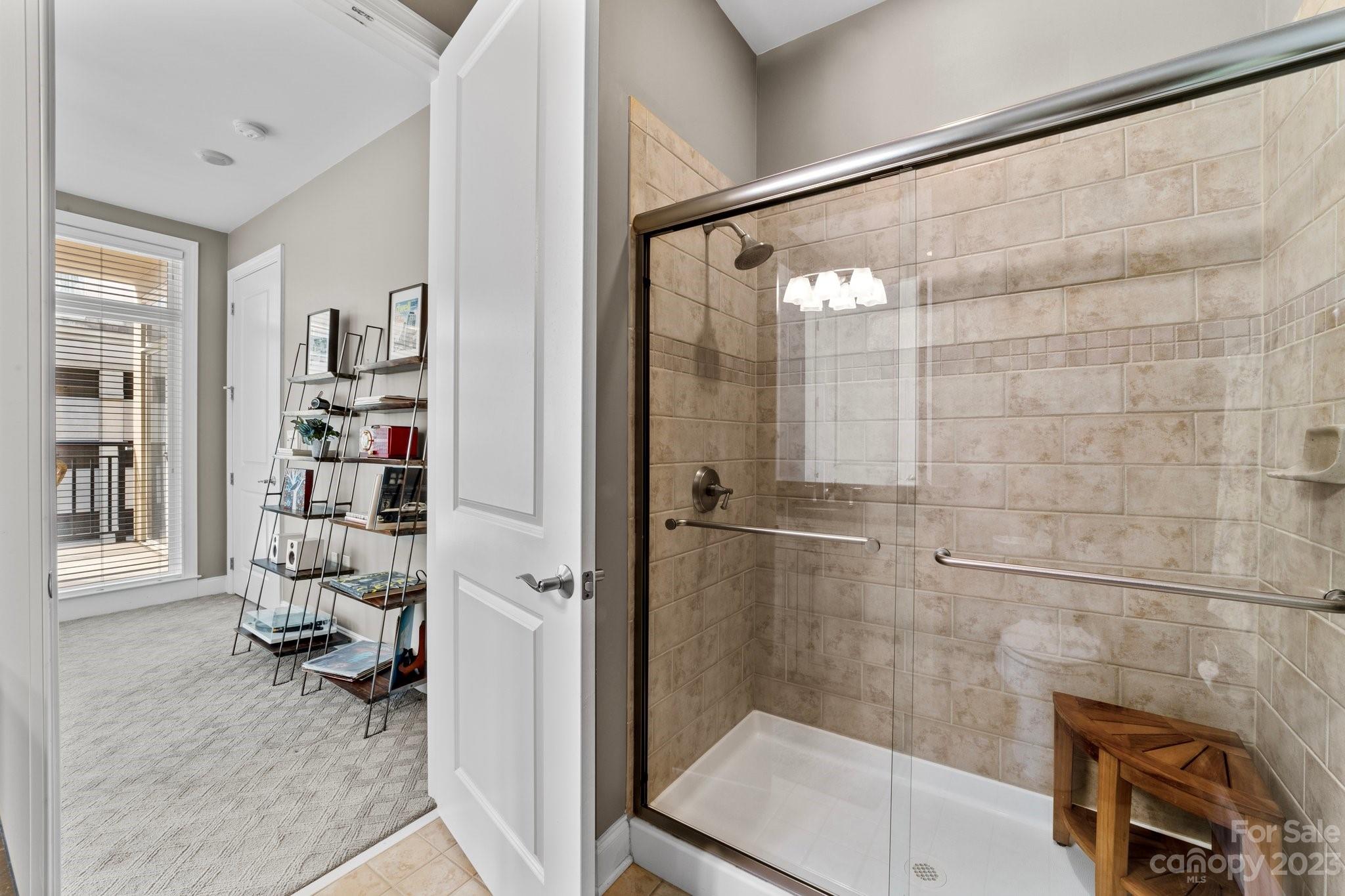 230 South Tryon Street, Unit 906 Charlotte, NC 28202 - Photo 21 of 27 a bathroom with a sink and a shower