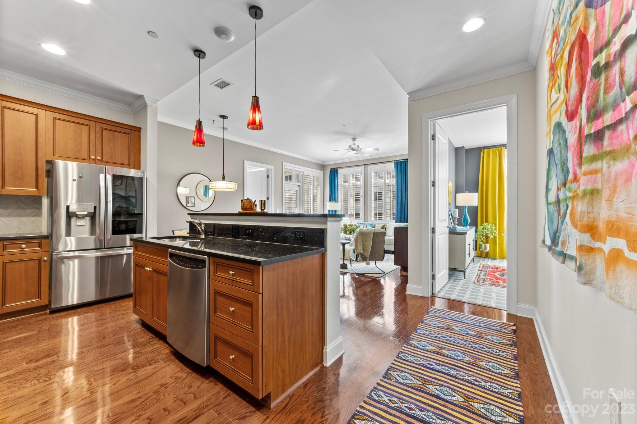 230 South Tryon Street, Unit 906 Charlotte, NC 28202 - Photo 3 of 27 a kitchen with stainless steel appliances granite countertop a stove and a refrigerator