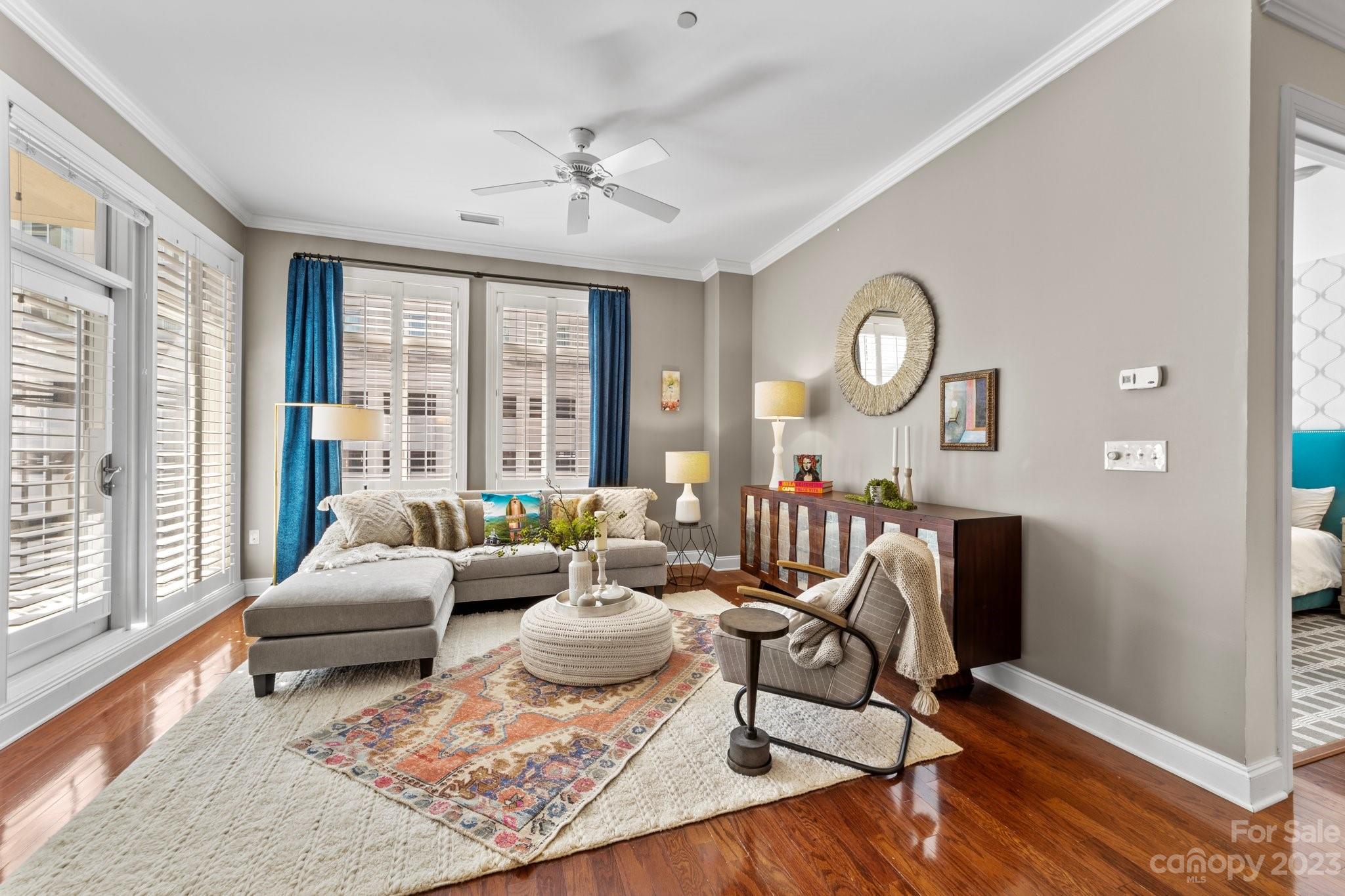 230 South Tryon Street, Unit 906 Charlotte, NC 28202 - Photo 8 of 27 a living room with furniture and wooden floor