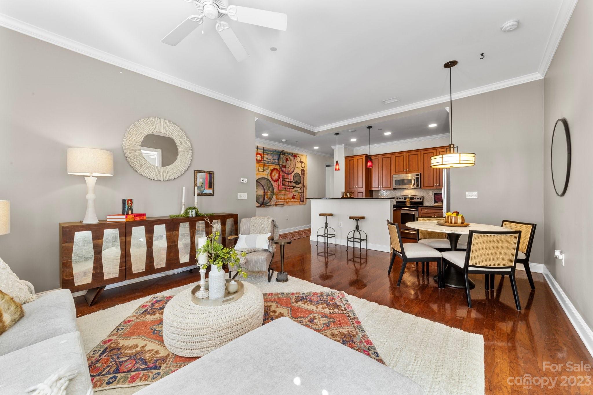 230 South Tryon Street, Unit 906 Charlotte, NC 28202 - Photo 10 of 27 a living room with furniture kitchen view and a wooden floor