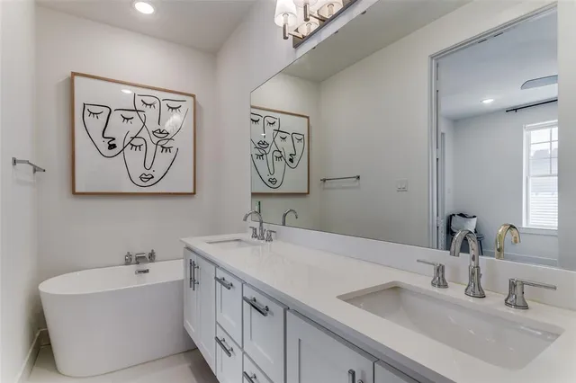 a bathroom with a double vanity sink and a bathtub