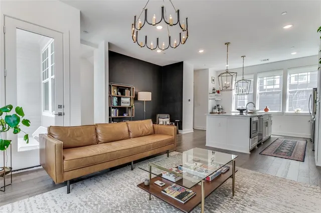 a living room with furniture and kitchen view
