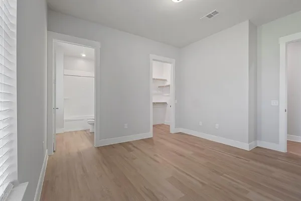 a view of walk in closet with empty racks