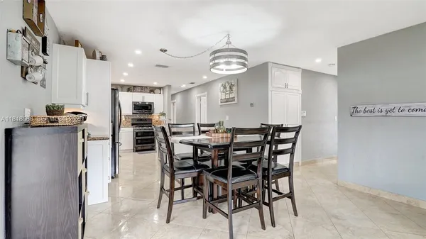 a kitchen with stainless steel appliances kitchen island a refrigerator stove and microwave