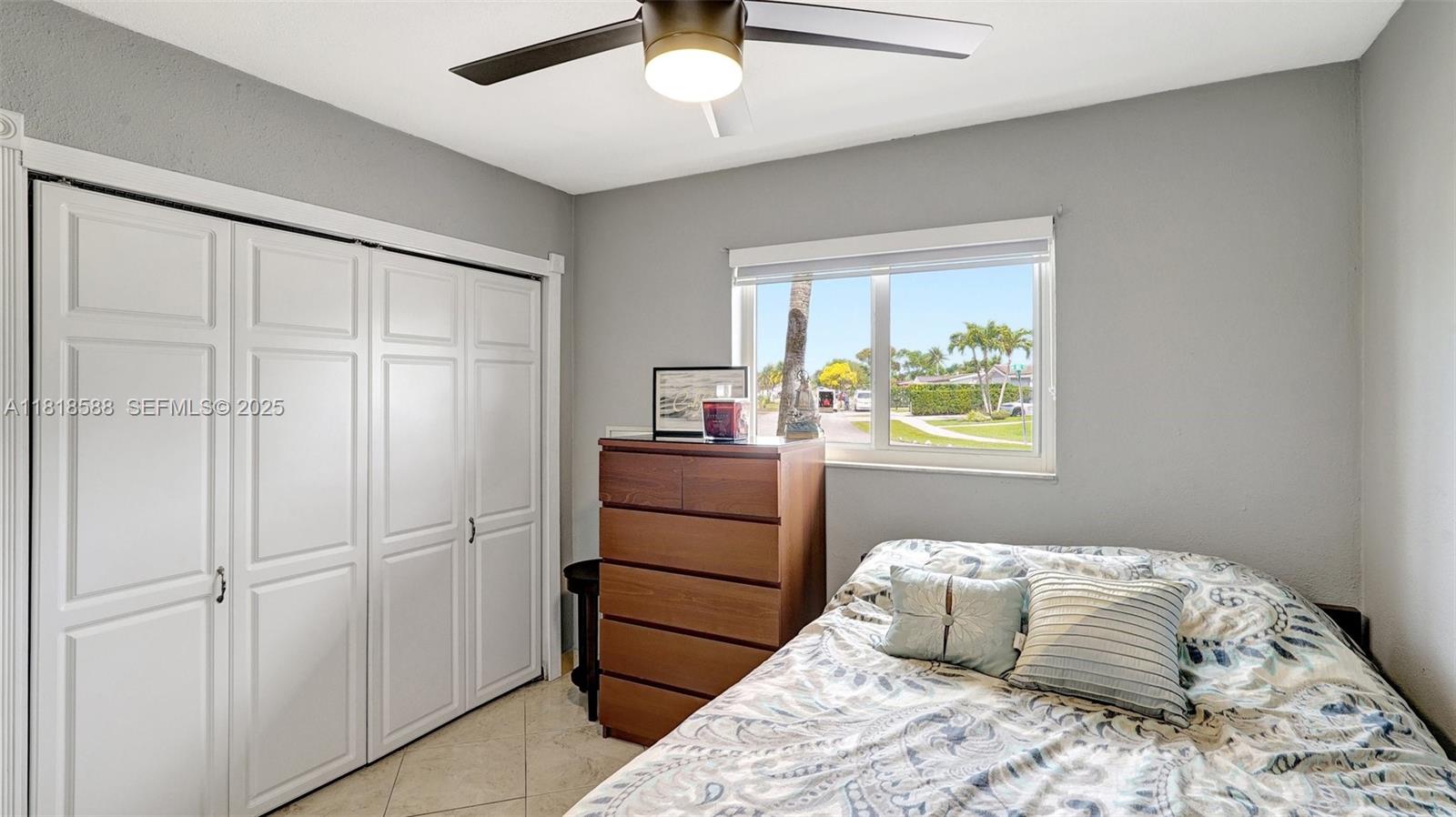 8540 Northwest 182nd Street Hialeah, FL 33015 - Photo 20 of 63 a bedroom with a bed and a window