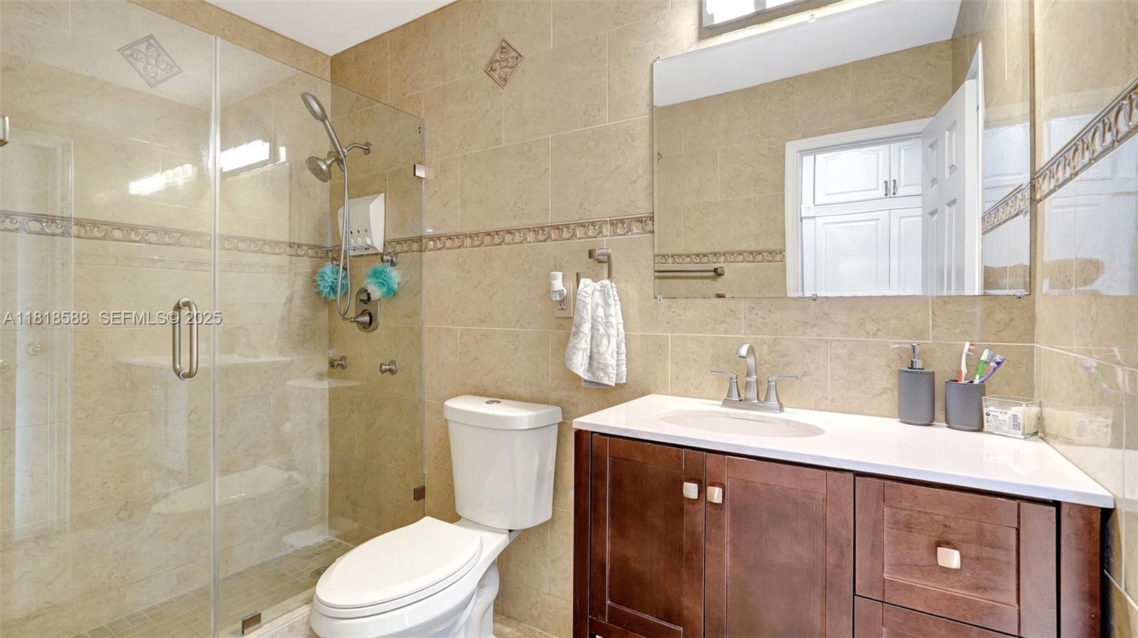 8540 Northwest 182nd Street Hialeah, FL 33015 - Photo 21 of 63 a bathroom with a sink a toilet and shower