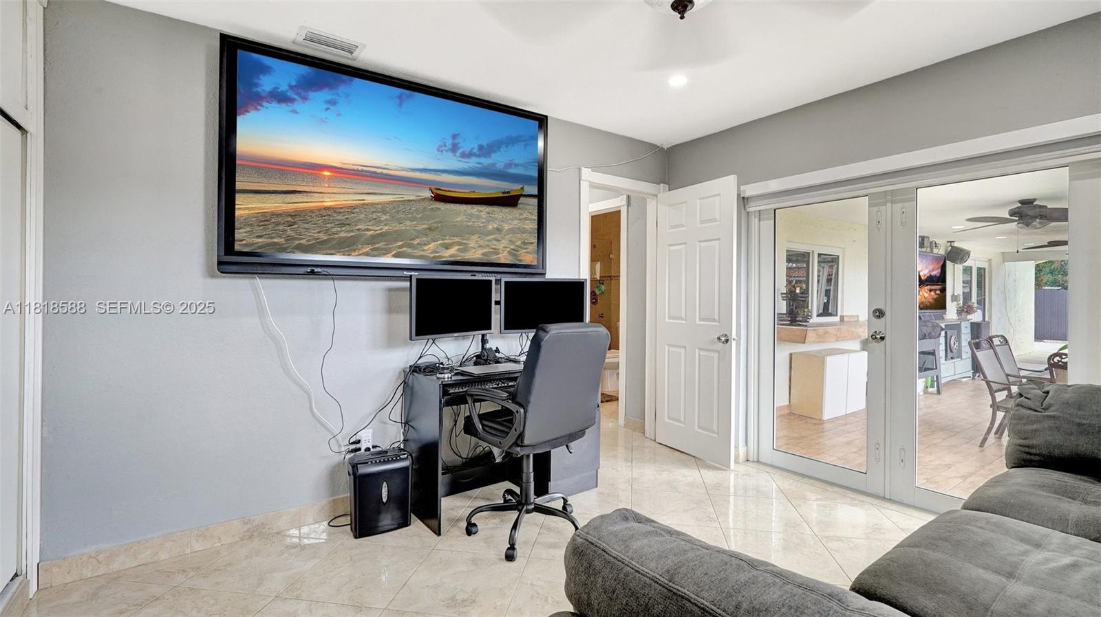 8540 Northwest 182nd Street Hialeah, FL 33015 - Photo 24 of 63 a living room with furniture and a flat screen tv
