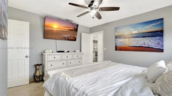 a living room with furniture a ceiling fan and a rug
