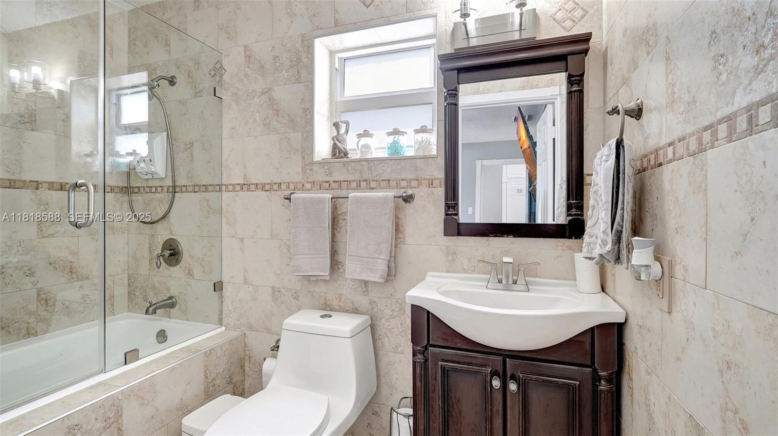 8540 Northwest 182nd Street Hialeah, FL 33015 - Photo 30 of 63 a bathroom with a sink a toilet and shower