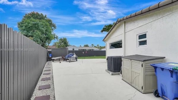 a view of a yard with a dining table and chairs