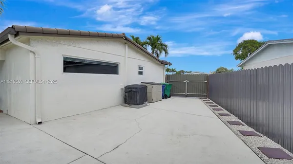 a view of a house with backyard and sitting area