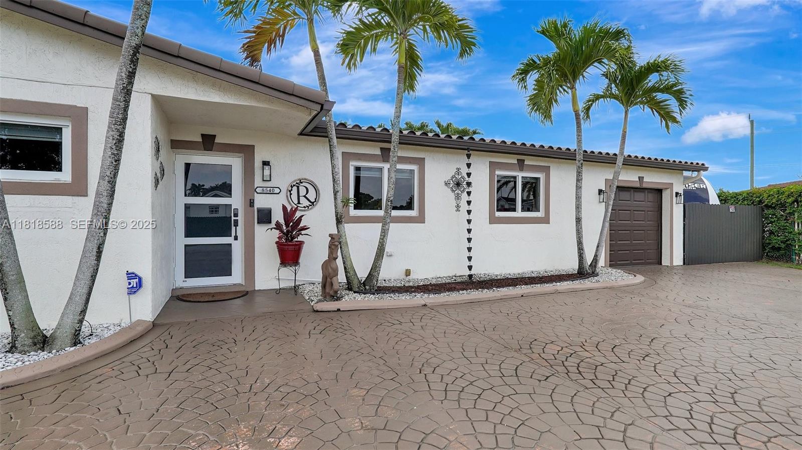 8540 Northwest 182nd Street Hialeah, FL 33015 - Photo 4 of 63 a view of a house with a garage