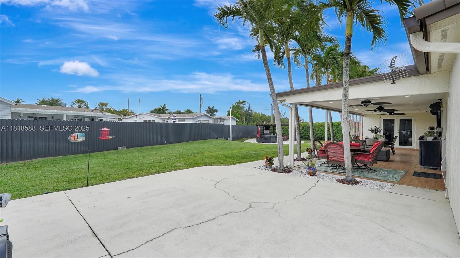 8540 Northwest 182nd Street Hialeah, FL 33015 - Photo 41 of 63 a view of a patio with a table and chairs under an umbrella