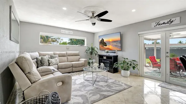 a living room with furniture and kitchen view