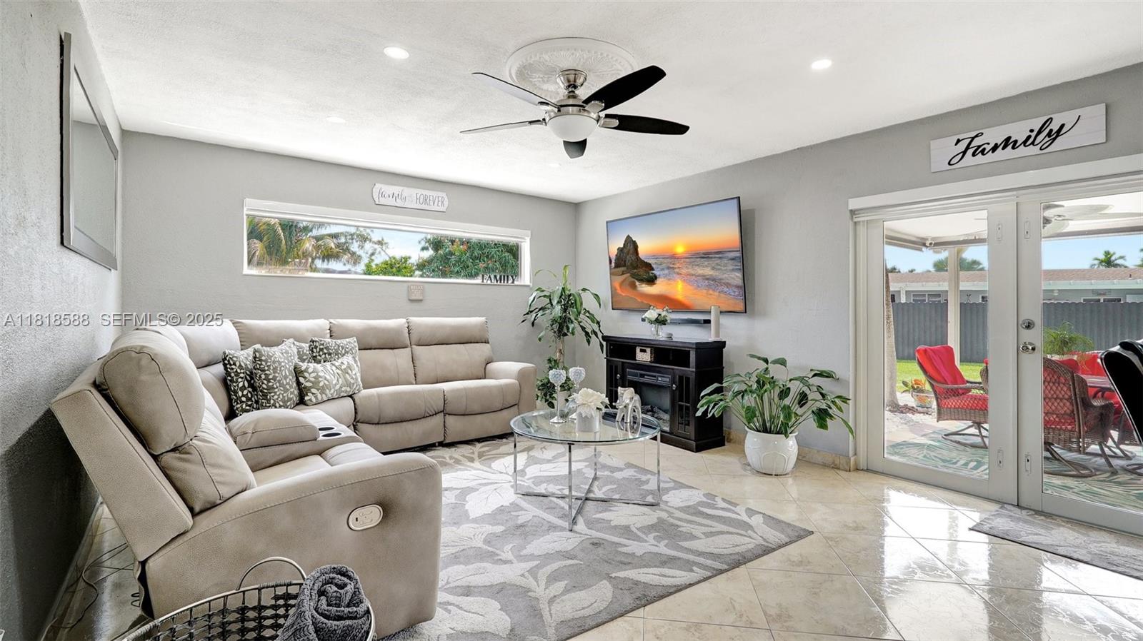 8540 Northwest 182nd Street Hialeah, FL 33015 - Photo 7 of 63 a living room with furniture and a flat screen tv