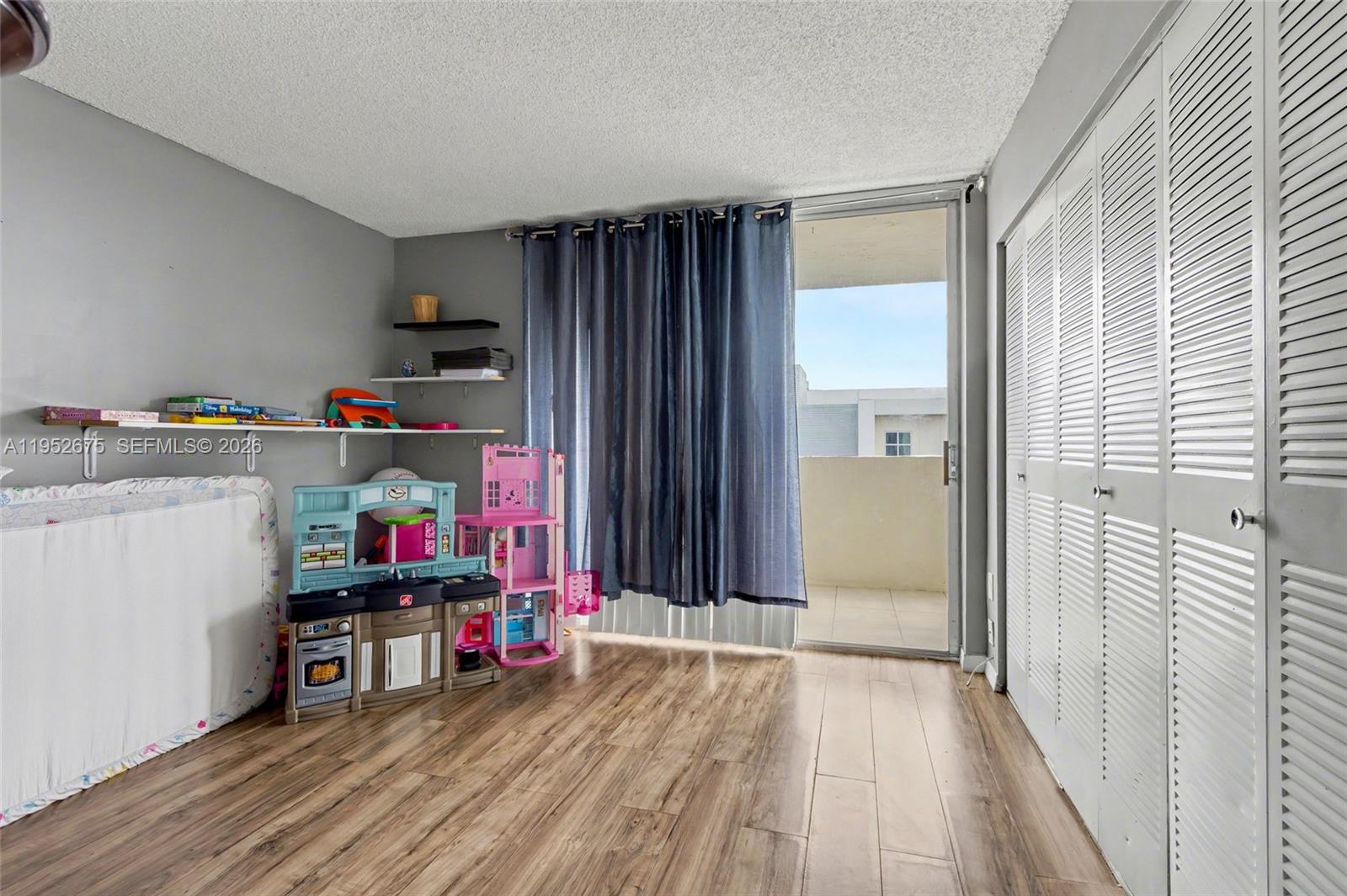 4675 West 18th Court, Unit 701 Hialeah, FL 33012 - Photo 5 of 14 a view of a kitchen with fridge and wooden floor
