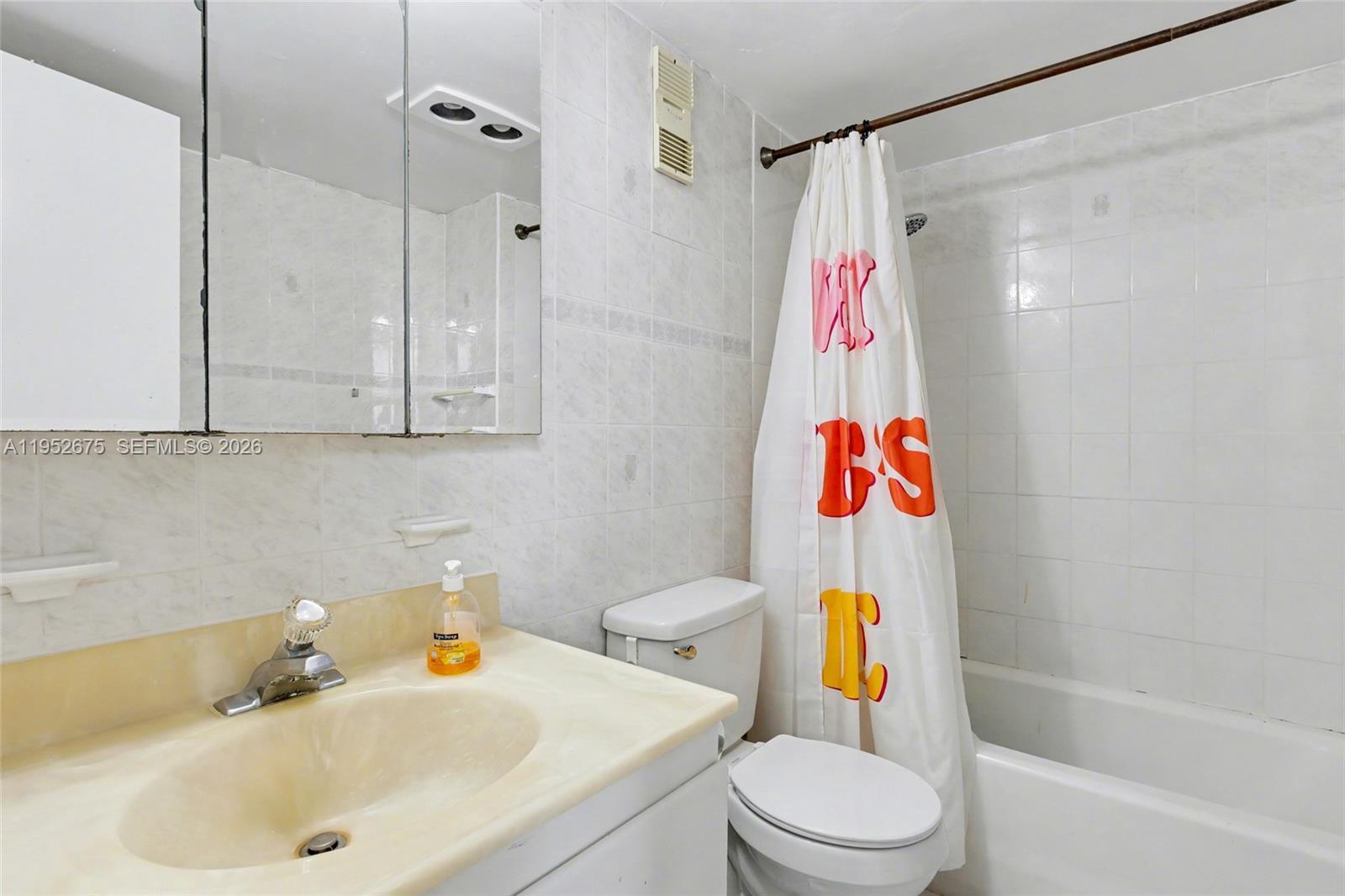 4675 West 18th Court, Unit 701 Hialeah, FL 33012 - Photo 6 of 14 a bathroom with a sink toilet and shower