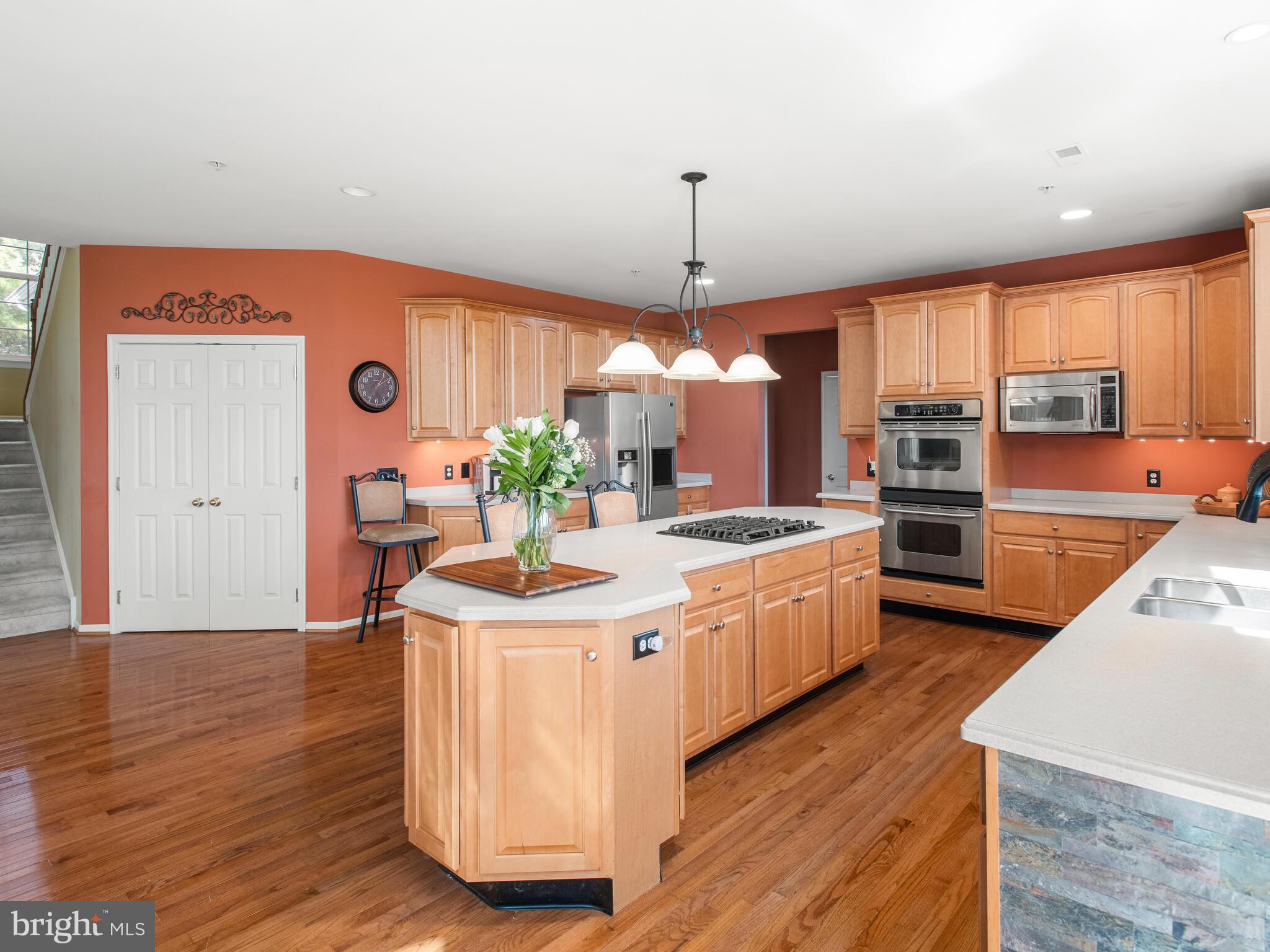 1180 Rupert Road Pottstown, PA 19464 - Photo 21 of 51 a kitchen with stainless steel appliances granite countertop a sink a stove and a wooden floors