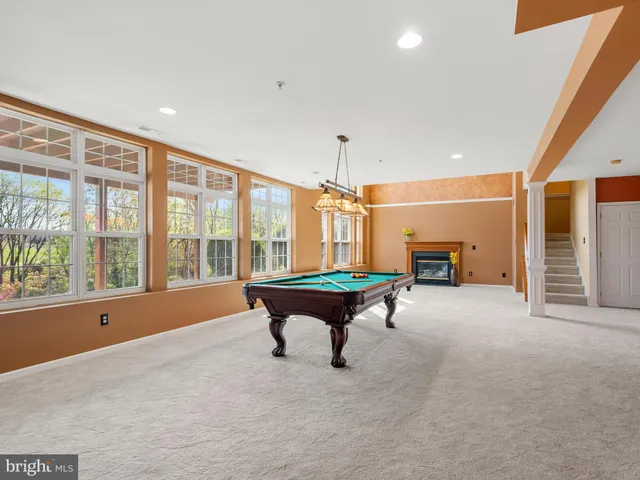 a bathroom with a toilet sink vanity and mirror