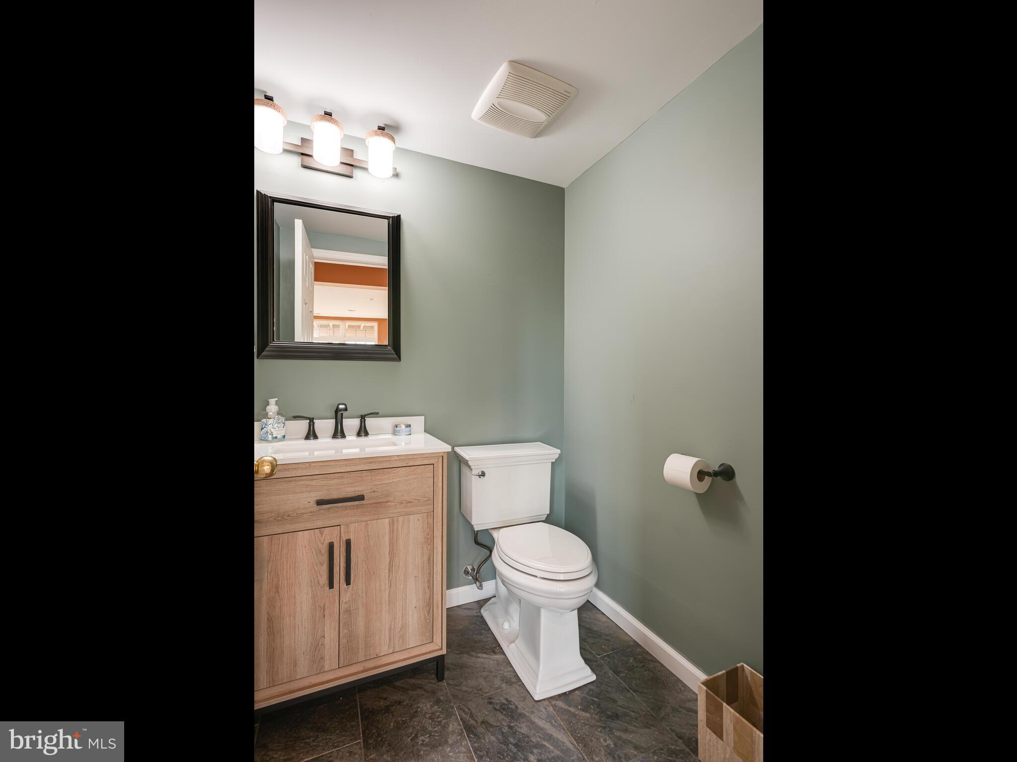 1180 Rupert Road Pottstown, PA 19464 - Photo 46 of 51 a bathroom with a toilet sink vanity and mirror