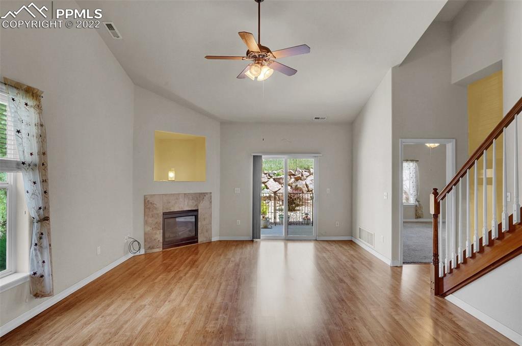 6578 Bethesda Point, Unit B Colorado Springs, CO 80918 - Photo 14 of 45 a view of an empty room with a window and wooden floor
