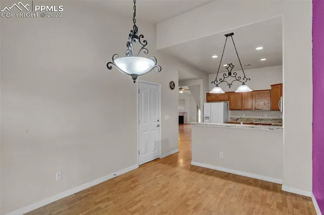 a view of a kitchen with a sink and refrigerator