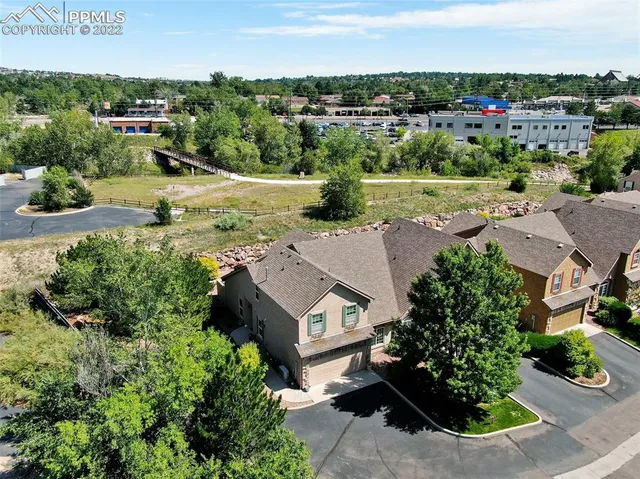 an aerial view of residential houses with outdoor space