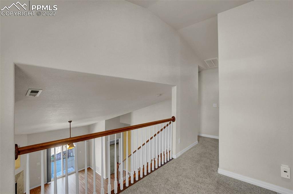 6578 Bethesda Point, Unit B Colorado Springs, CO 80918 - Photo 32 of 45 a view of a hallway with wooden floor and entryway