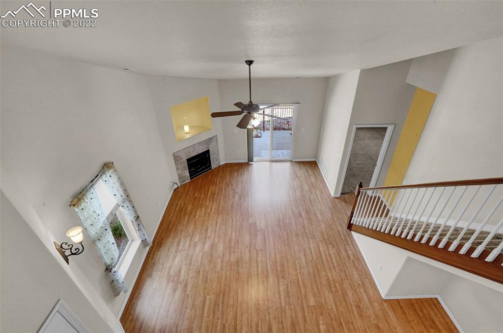6578 Bethesda Point, Unit B Colorado Springs, CO 80918 - Photo 33 of 45 a view of a livingroom with furniture stairs wooden floor and windows