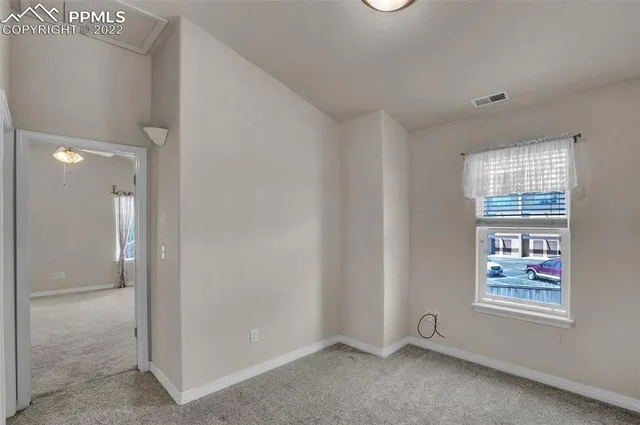 a view of an empty room with a window