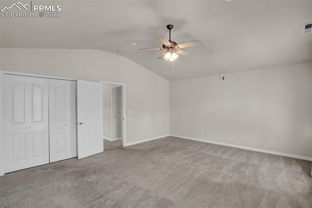 6578 Bethesda Point, Unit B Colorado Springs, CO 80918 - Photo 38 of 45 an empty room with a window and ceiling fan