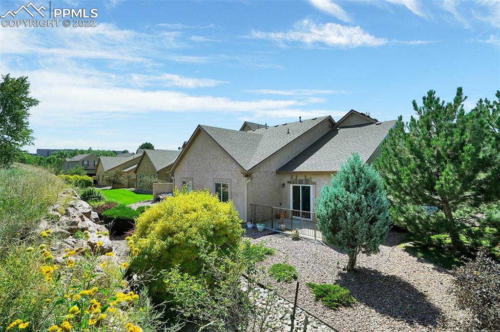 6578 Bethesda Point, Unit B Colorado Springs, CO 80918 - Photo 40 of 45 a view of a house with a big yard plants and large trees