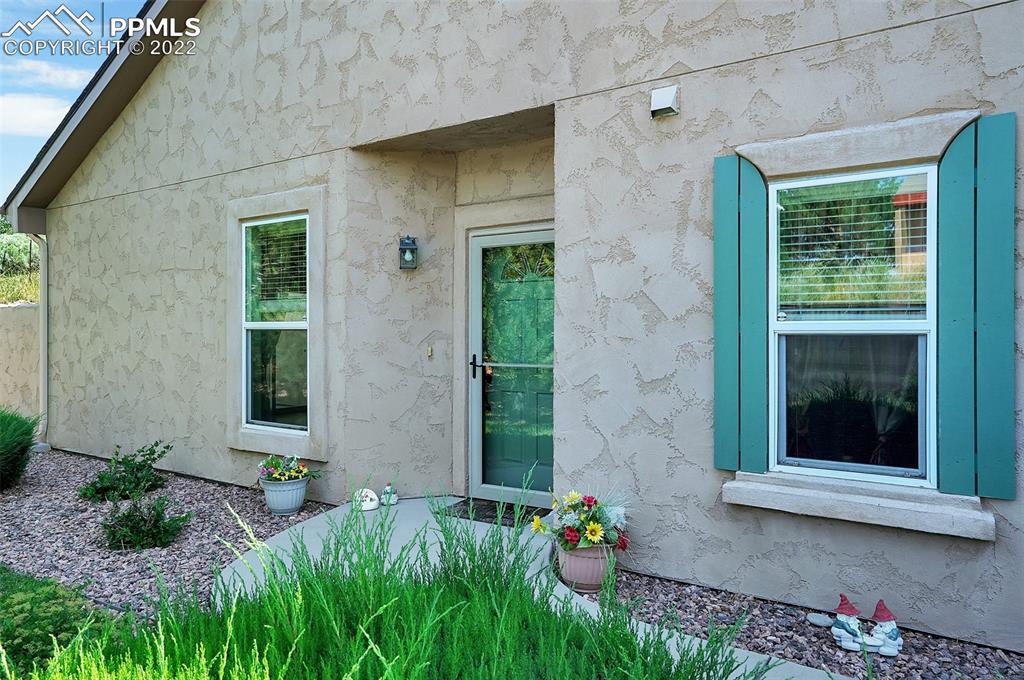 6578 Bethesda Point, Unit B Colorado Springs, CO 80918 - Photo 6 of 45 a front view of a house with a porch