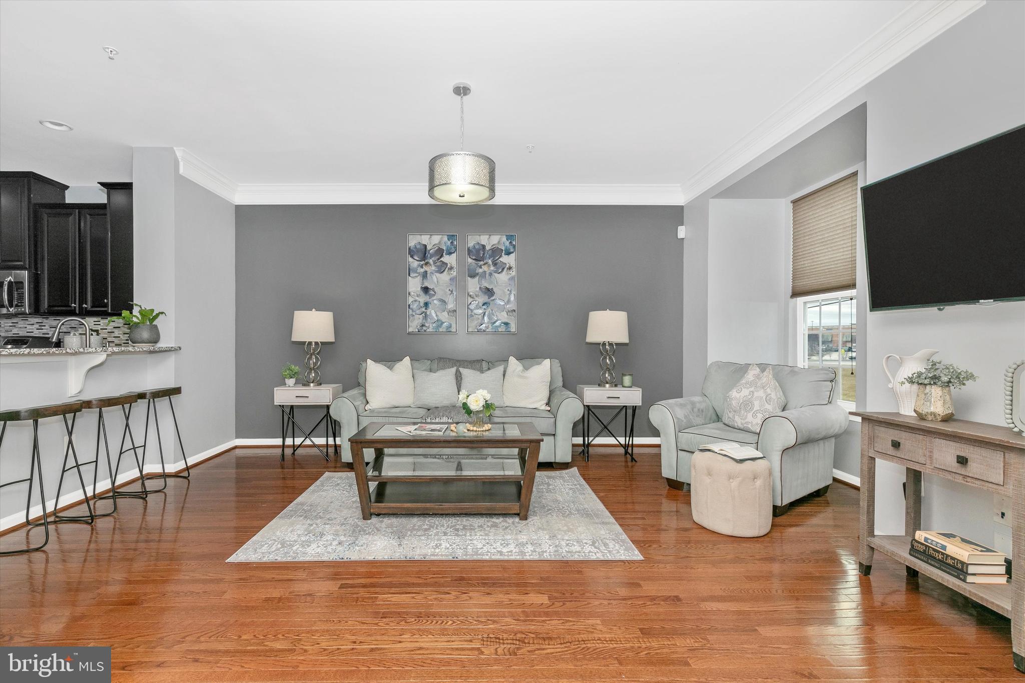 7821 Wormans Mill Road Frederick, MD 21701 - Photo 20 of 44 a living room with furniture wooden floor and a flat screen tv