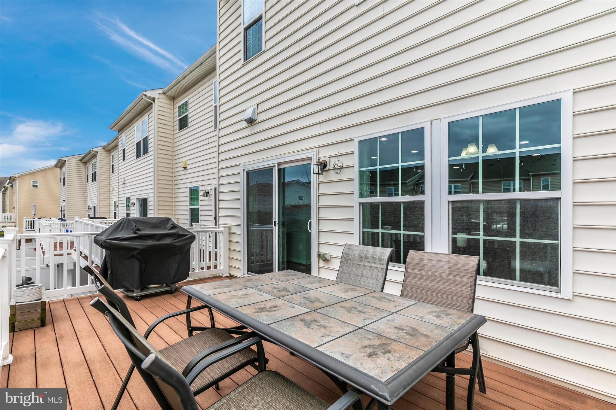 7821 Wormans Mill Road Frederick, MD 21701 - Photo 24 of 44 a view of a patio with a table and chairs