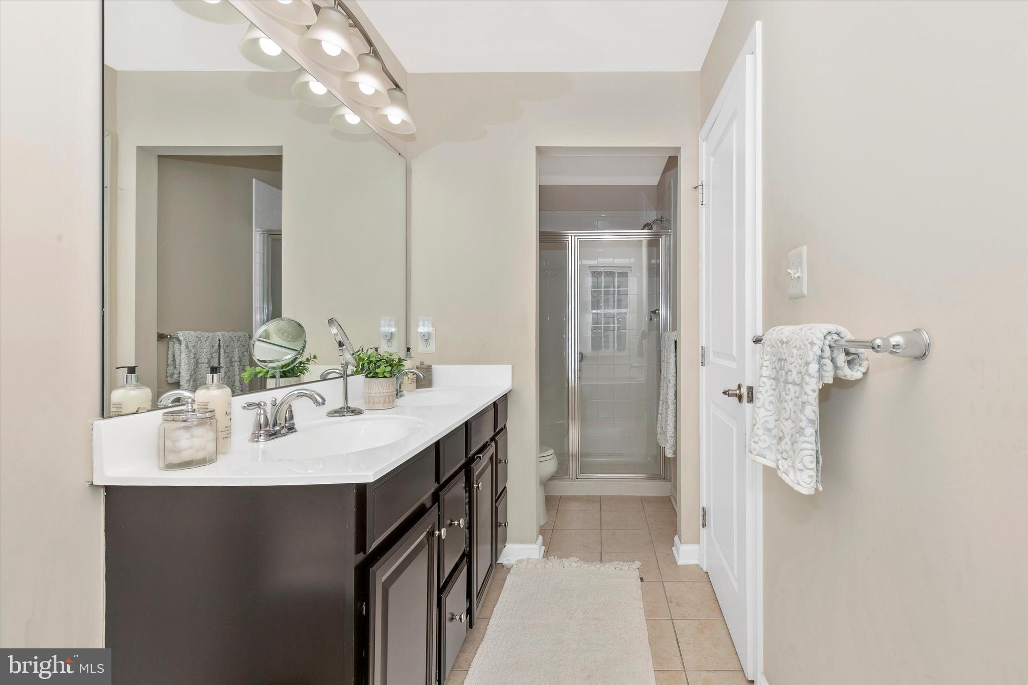 7821 Wormans Mill Road Frederick, MD 21701 - Photo 27 of 44 a spacious bathroom with a sink shower and a mirror