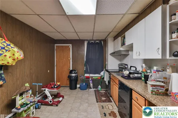 a kitchen with furniture a refrigerator and a stove