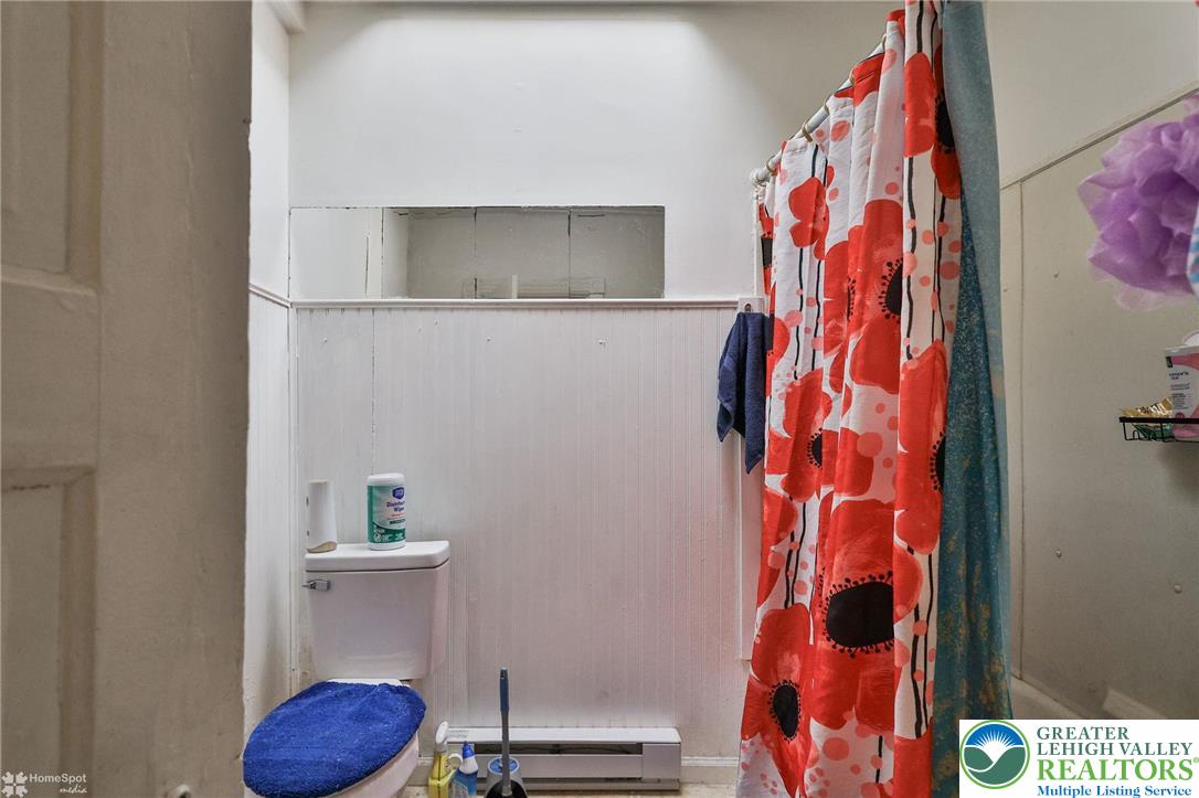 705 North Front Street Allentown, PA 18102 - Photo 19 of 44 a bathroom with a toilet and a shower curtain