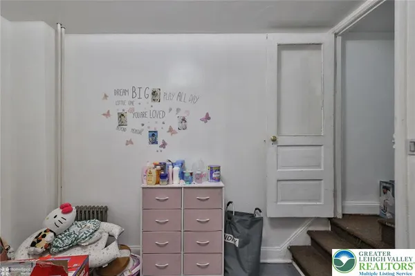 a view of a room with toys and wooden floor