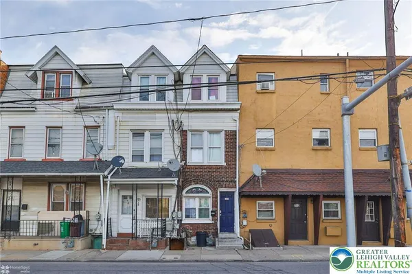 a front view of a residential apartment building with a yard