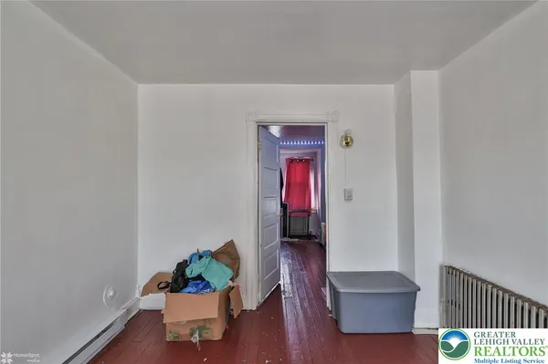 an empty room with wooden floor and closet