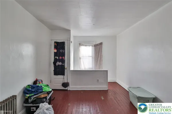 a bedroom with furniture and a window