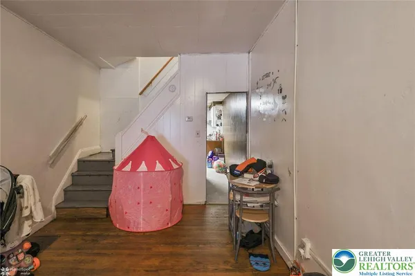 a view of a hallway with entryway wooden floor and front door