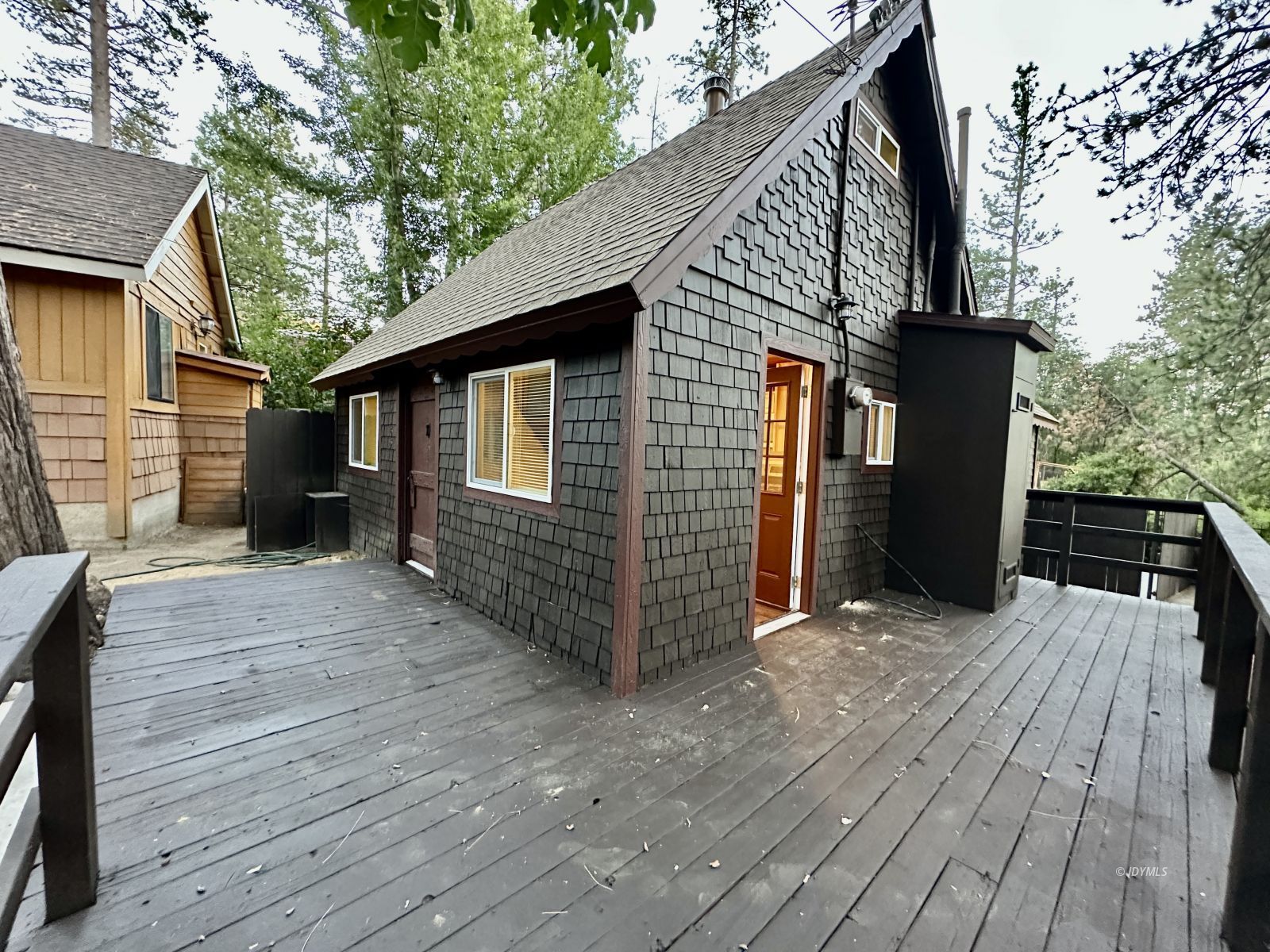 25165 Cedar, Unit A Idyllwild, CA 92549 - Photo 5 of 26 a backyard of a house with wooden floor and outdoor seating