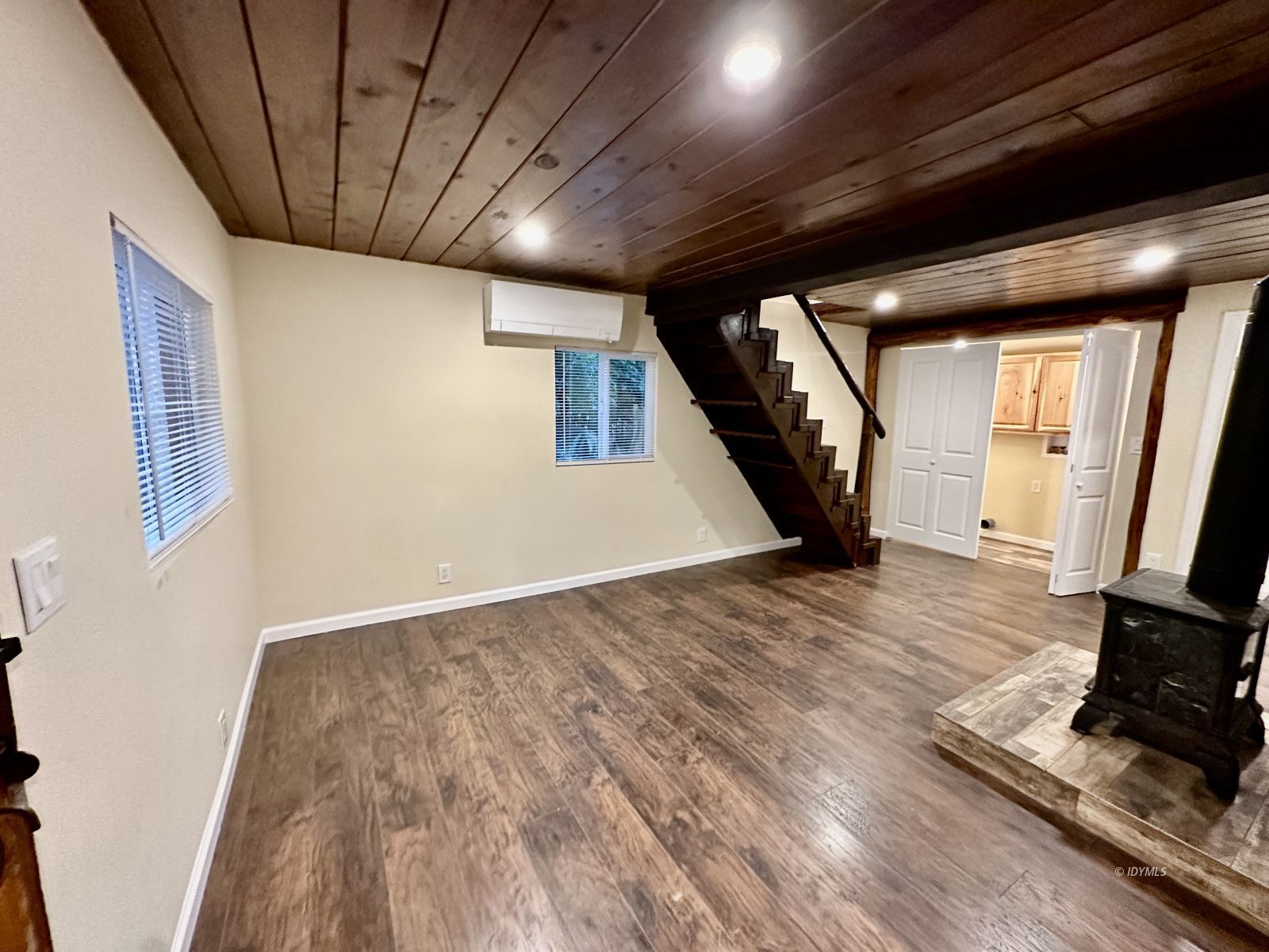 25165 Cedar, Unit A Idyllwild, CA 92549 - Photo 7 of 26 a view of an empty room with wooden floor and a window