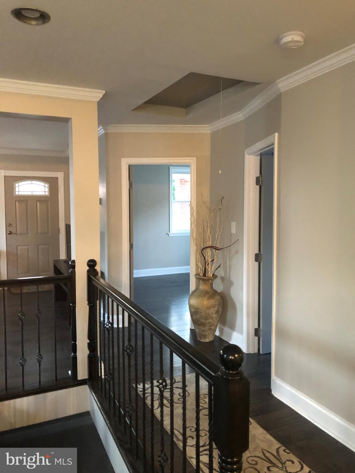 238 Pinewood Road Baltimore, MD 21222 - Photo 2 of 22 a view of a hallway view with wooden floor and staircase