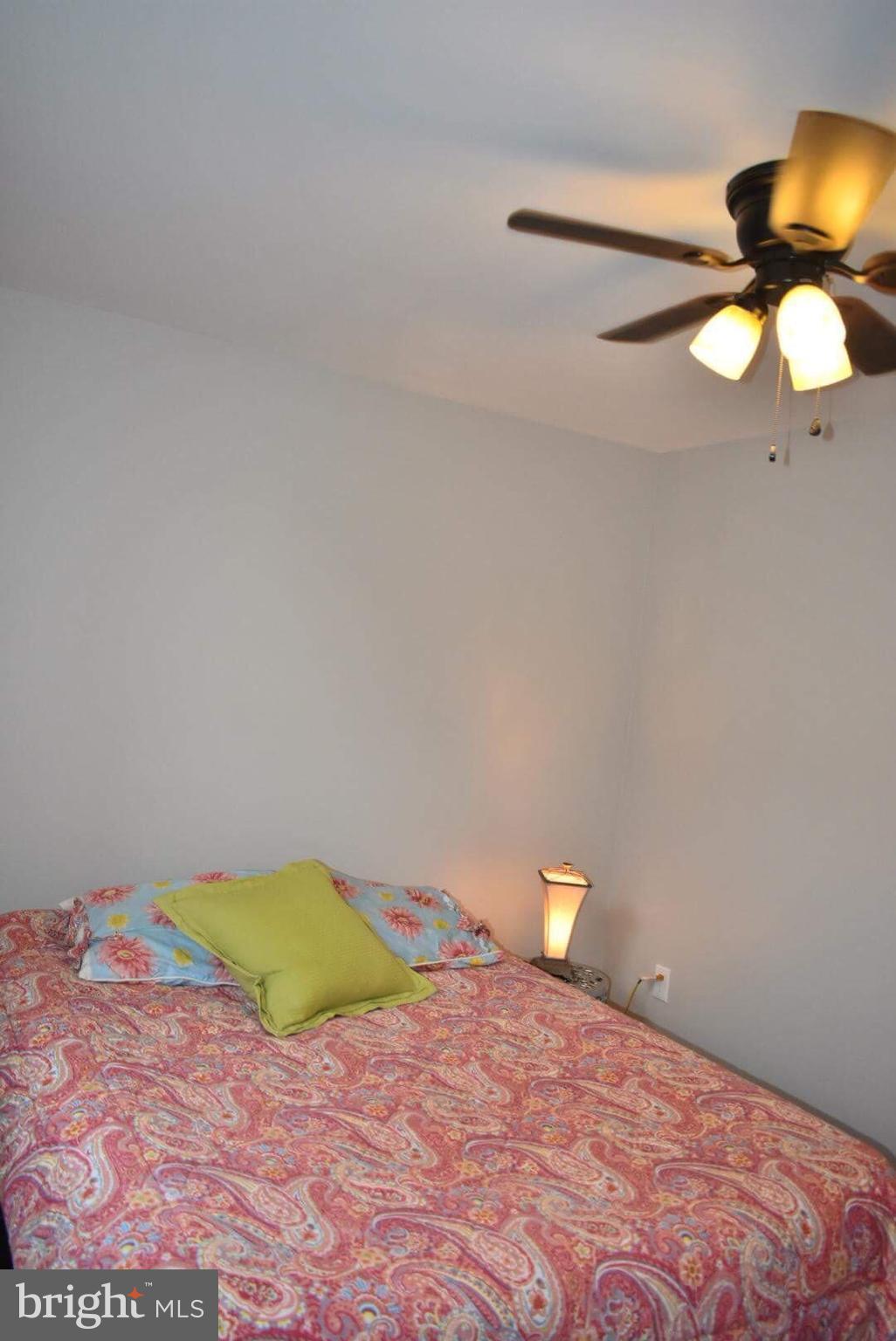 238 Pinewood Road Baltimore, MD 21222 - Photo 15 of 22 a bedroom with a bed and a chandelier