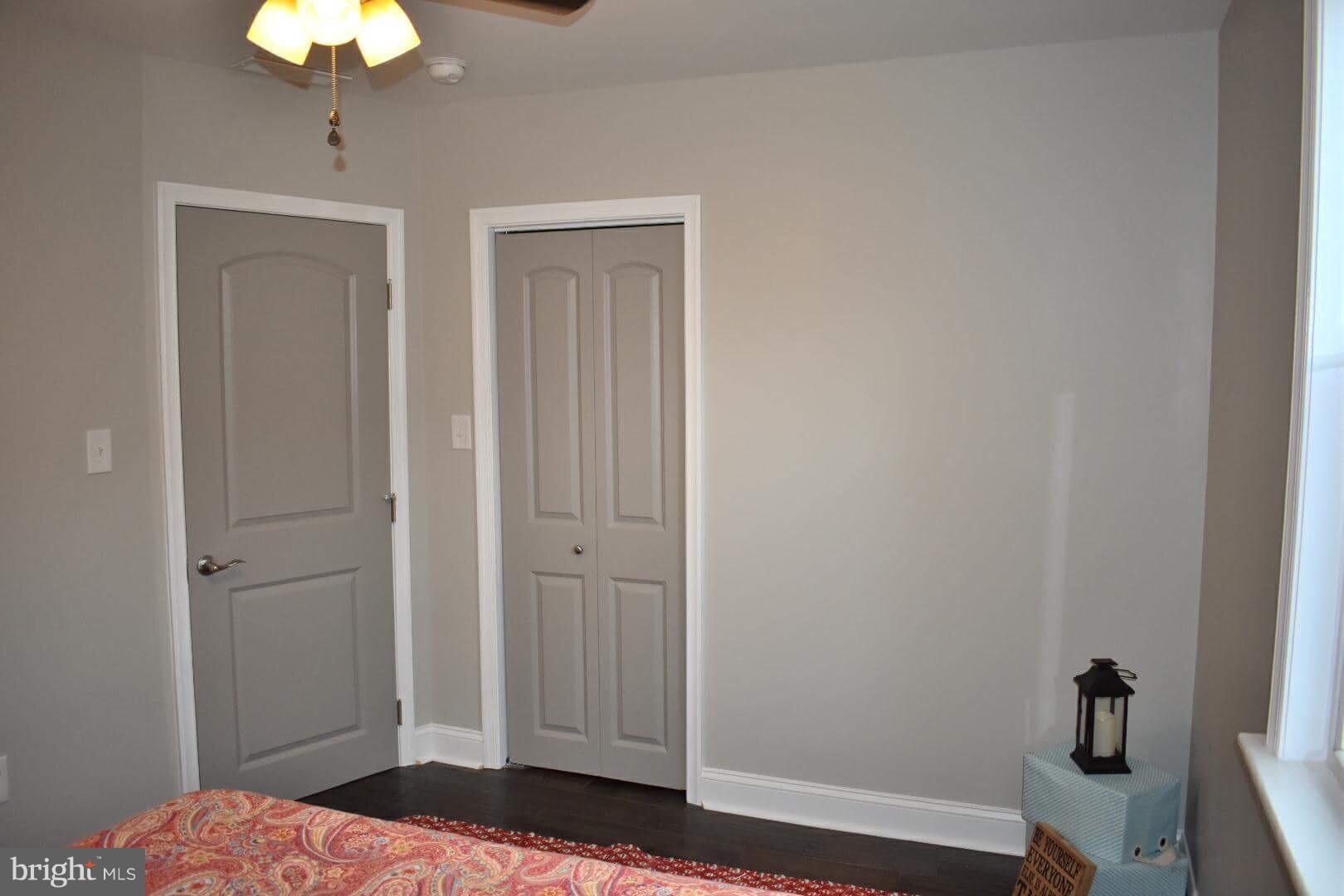 238 Pinewood Road Baltimore, MD 21222 - Photo 16 of 22 a bedroom with a bed and a chandelier